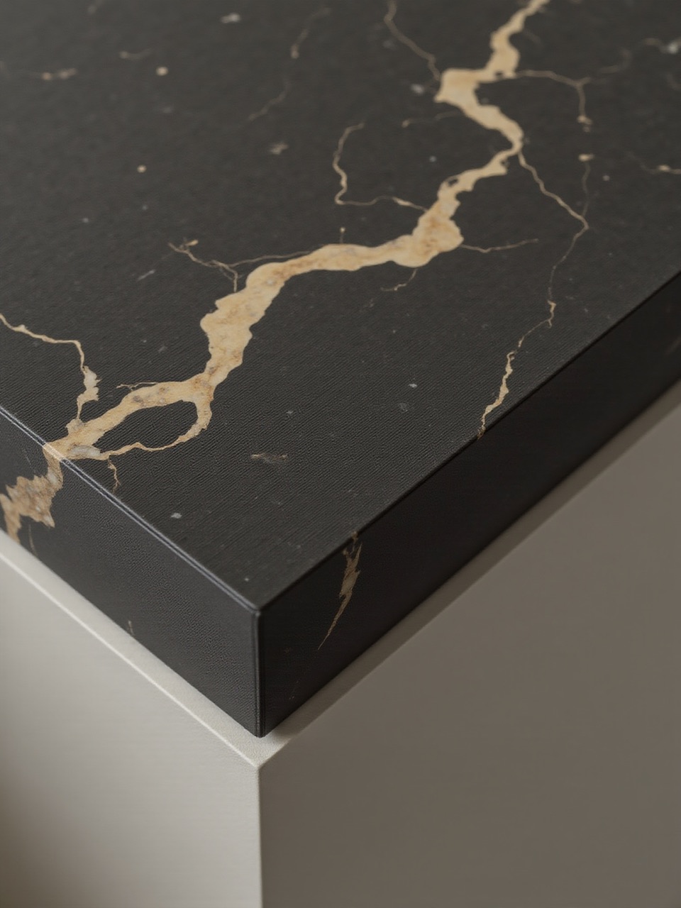 Black marble slab with gold veining on a cabinet corner
